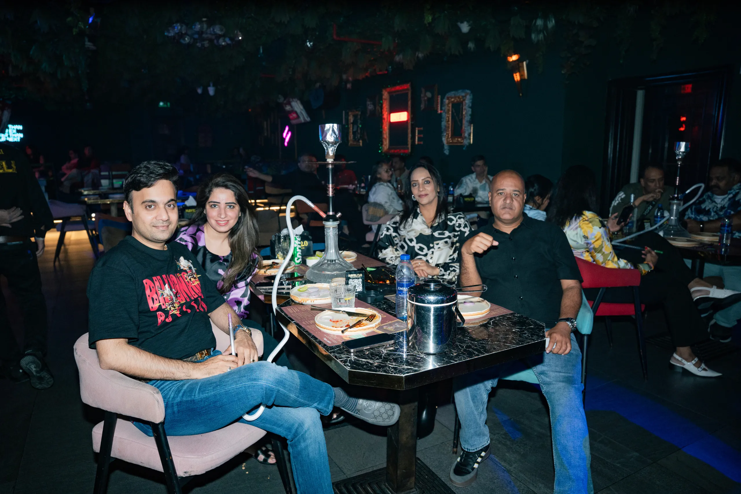 Friends sharing a meal and laughing together indoors
